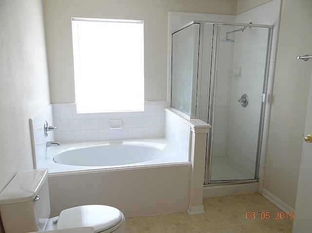 bathroom with toilet and shower with separate bathtub