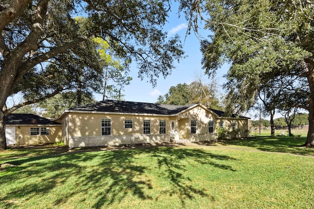 back of house with a lawn