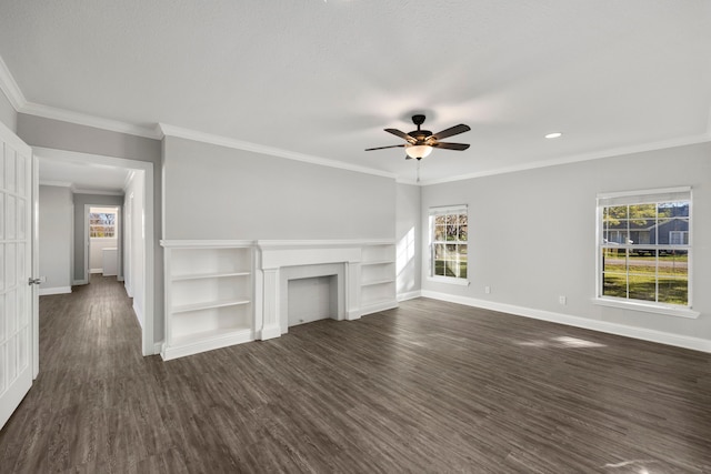 unfurnished living room with plenty of natural light, dark hardwood / wood-style floors, and ornamental molding