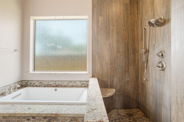 bathroom featuring separate shower and tub