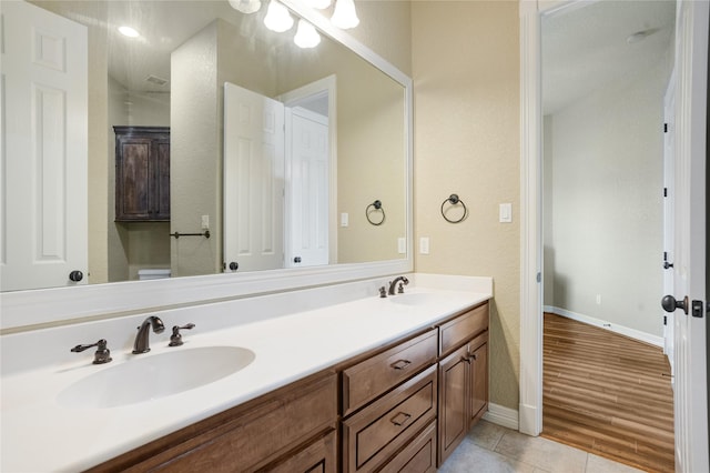 bathroom with vanity and wood-type flooring