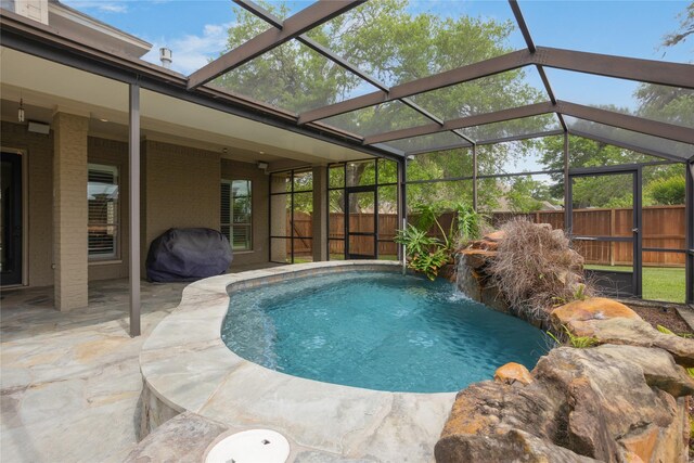 view of swimming pool featuring pool water feature and a patio area