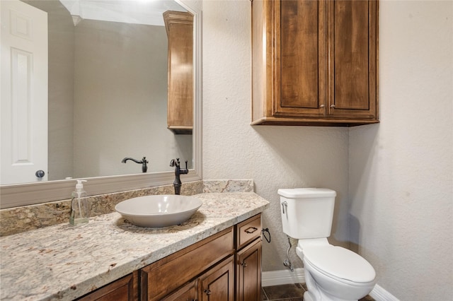 bathroom with tile patterned flooring, vanity, and toilet