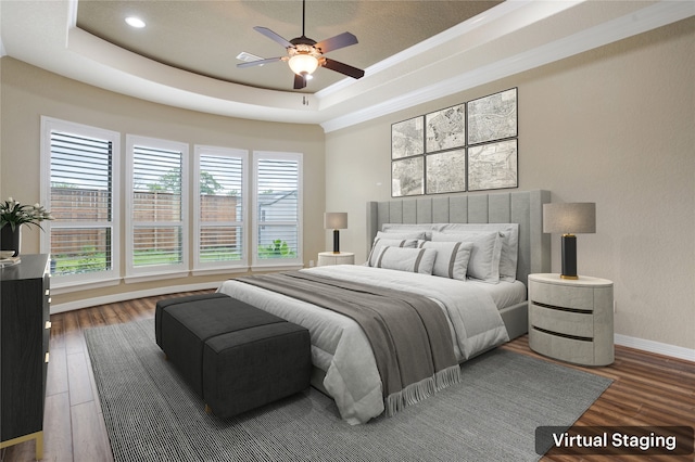 bedroom featuring a raised ceiling, multiple windows, ceiling fan, and dark hardwood / wood-style floors