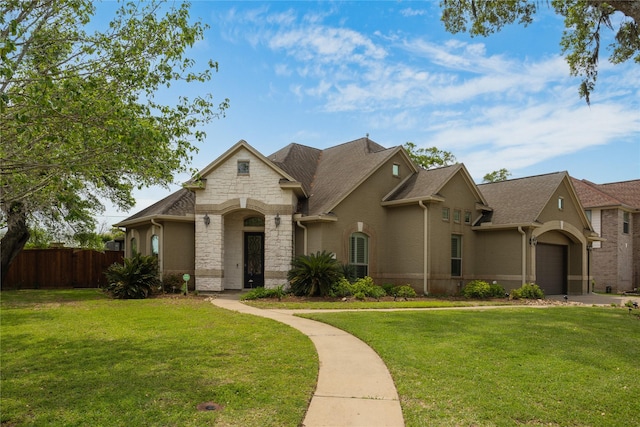 view of front facade featuring a front yard and a garage