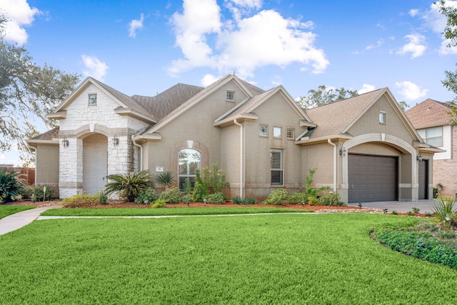 view of front facade with a front yard and a garage