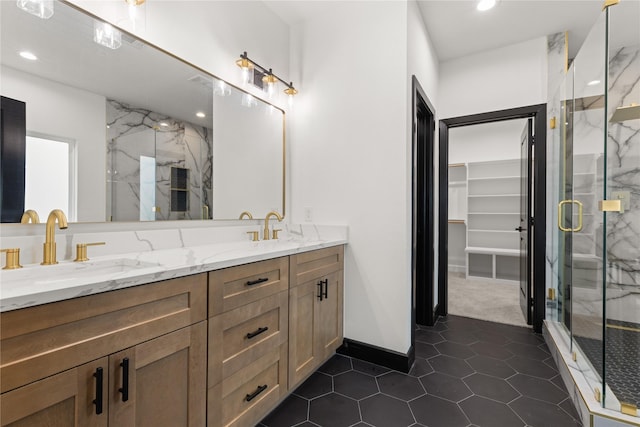 bathroom featuring tile patterned flooring, vanity, and walk in shower