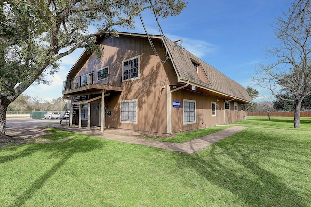 rear view of property featuring a lawn