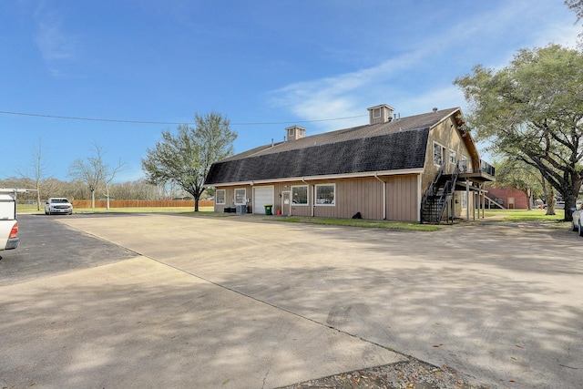 view of property exterior with a garage and central air condition unit