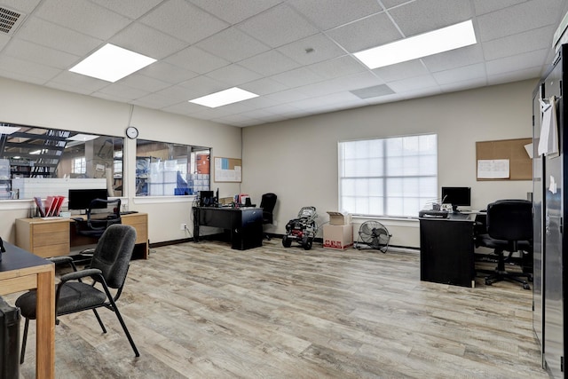 home office featuring light hardwood / wood-style flooring and a drop ceiling