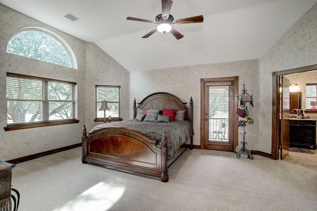 bedroom with light colored carpet, vaulted ceiling, multiple windows, and ceiling fan