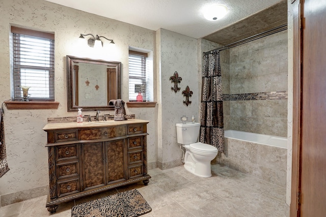 full bathroom featuring shower / bath combo, vanity, a textured ceiling, tile patterned flooring, and toilet