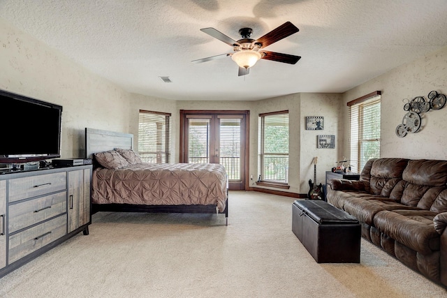 carpeted bedroom with access to exterior, a textured ceiling, and ceiling fan