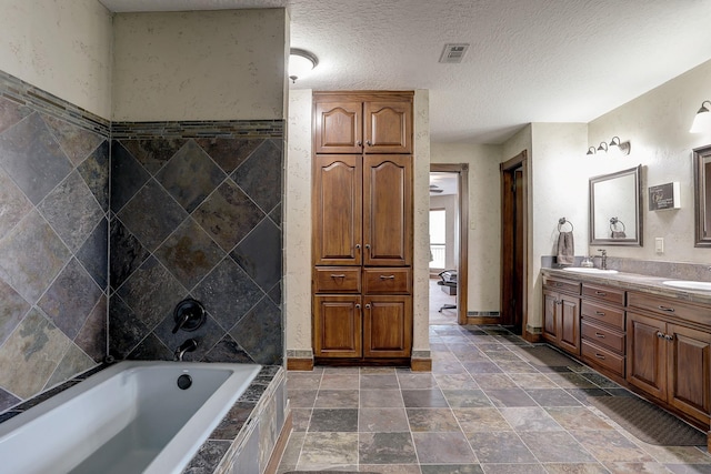 bathroom featuring vanity and a textured ceiling