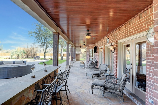 view of patio featuring a bar and ceiling fan