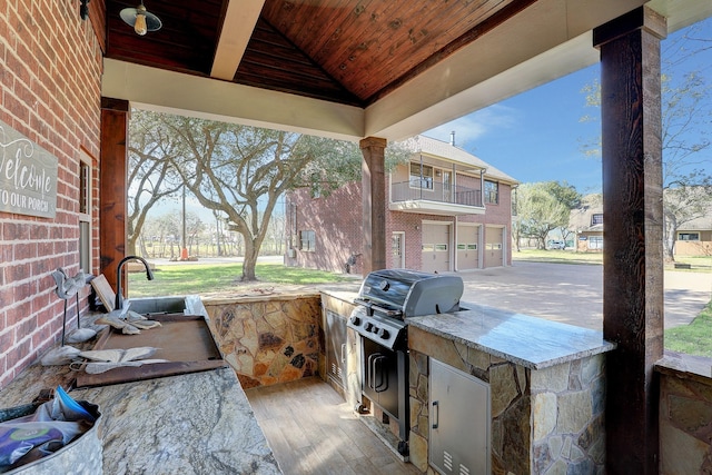 view of patio / terrace with an outdoor kitchen, sink, and grilling area