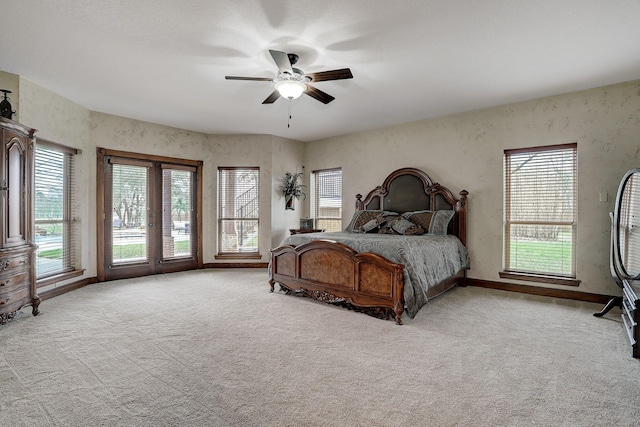 bedroom featuring ceiling fan, french doors, and light colored carpet