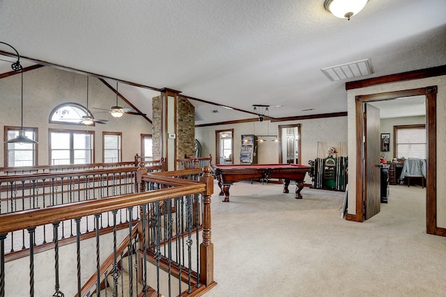 playroom with a wealth of natural light, a textured ceiling, billiards, and light carpet