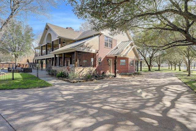 view of side of property featuring a lawn and a porch