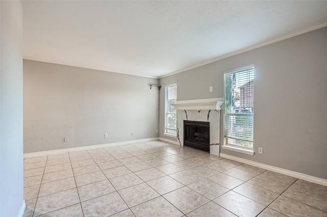 unfurnished living room with crown molding and light tile patterned floors