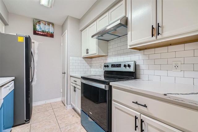 kitchen with white cabinetry, light stone countertops, backsplash, light tile patterned floors, and appliances with stainless steel finishes