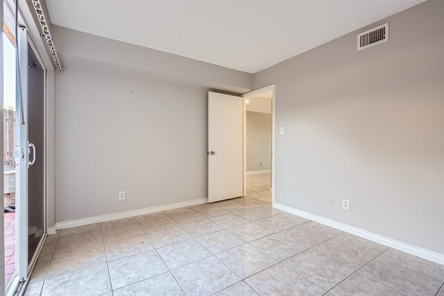 empty room with light tile patterned floors