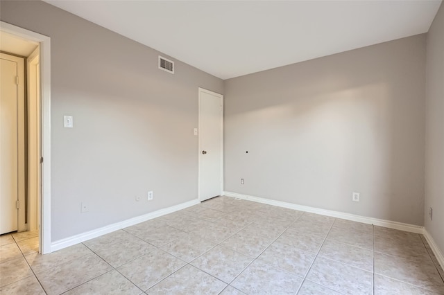 unfurnished room with light tile patterned flooring