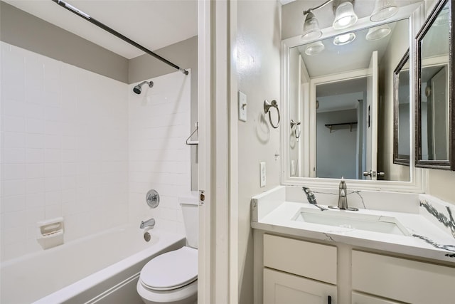 full bathroom with toilet, vanity, and tiled shower / bath