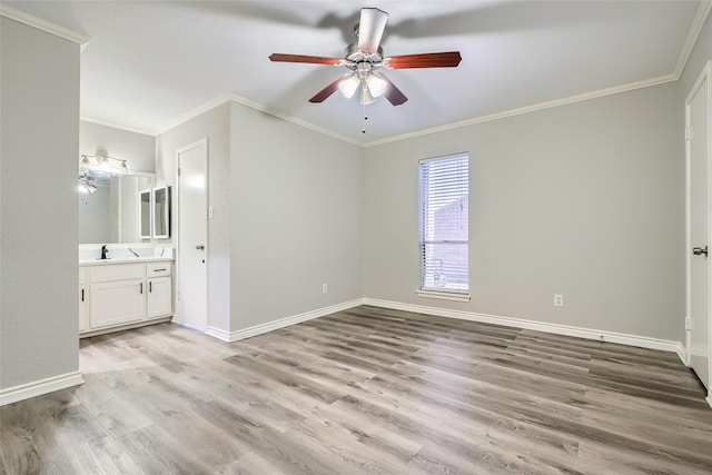 unfurnished bedroom with ensuite bath, ceiling fan, light hardwood / wood-style flooring, and crown molding