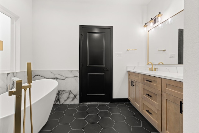 bathroom with tile patterned floors, a bathing tub, vanity, and tile walls