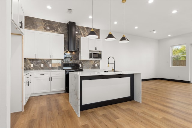 kitchen featuring electric stove, white cabinets, hanging light fixtures, and wall chimney range hood