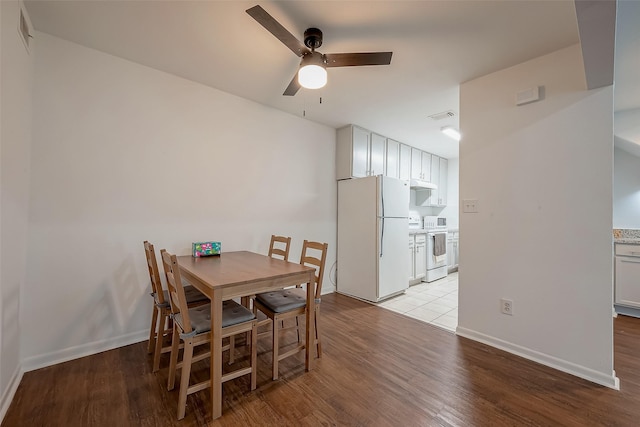 dining area with ceiling fan and light hardwood / wood-style floors