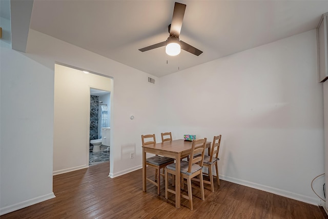 dining space with ceiling fan and dark hardwood / wood-style floors