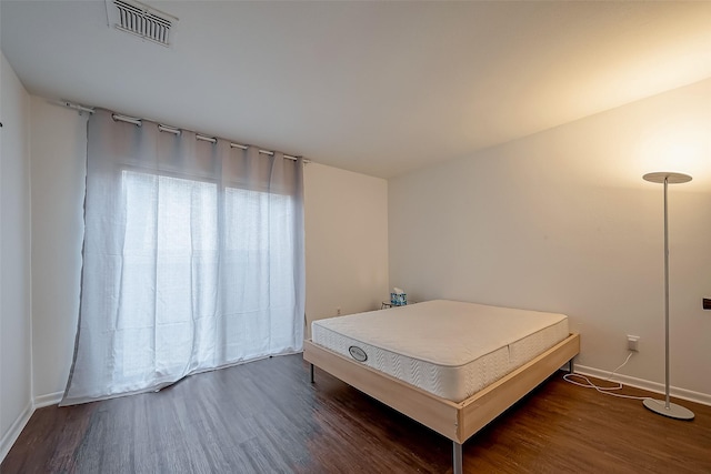 bedroom featuring dark hardwood / wood-style flooring