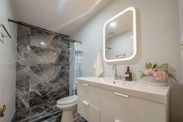 bathroom featuring curtained shower, vanity, tile walls, and toilet