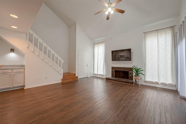 unfurnished living room with dark hardwood / wood-style floors, ceiling fan, and a healthy amount of sunlight