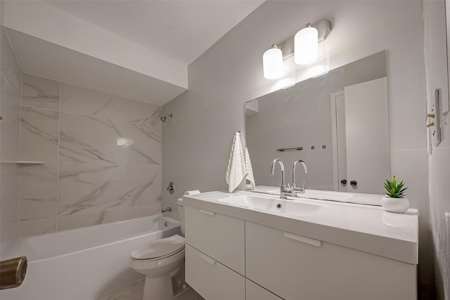 full bathroom with toilet, vanity, and tiled shower / bath