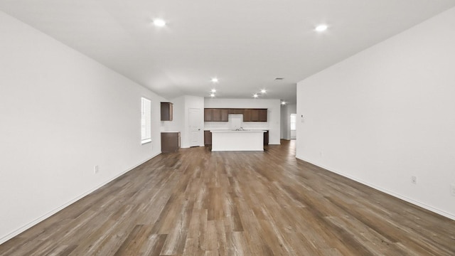 unfurnished living room with dark hardwood / wood-style floors