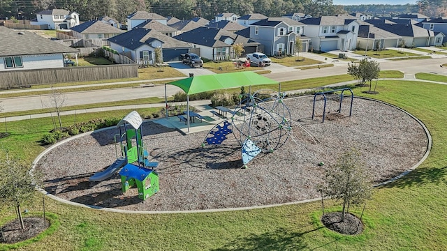 view of home's community with a playground and a yard