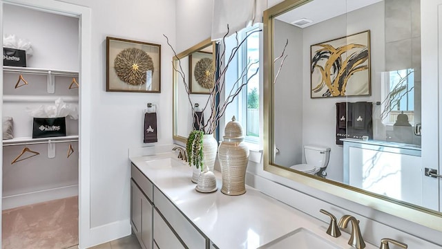 bathroom featuring tile patterned floors, vanity, and toilet