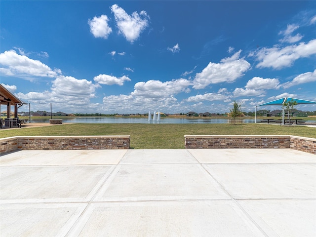 view of patio with a water view