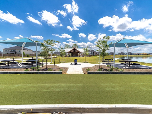 view of jungle gym with a gazebo, a water view, and a lawn