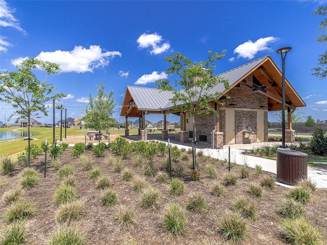 view of community with a gazebo and a water view