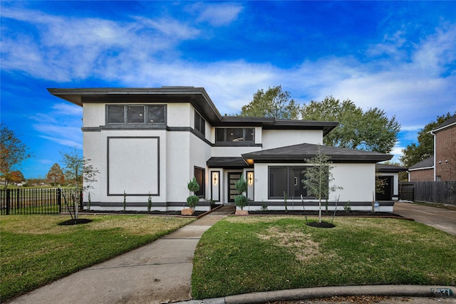 prairie-style house featuring a garage and a front yard