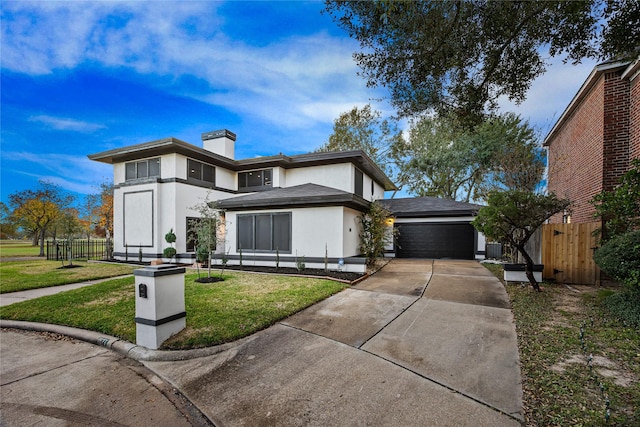 view of front facade featuring a garage and a front lawn