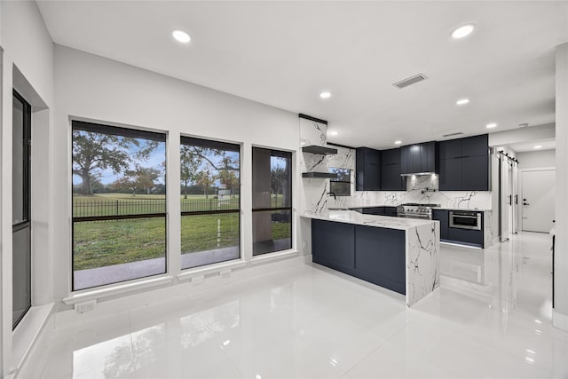 kitchen with kitchen peninsula, decorative backsplash, light tile patterned flooring, and light stone counters