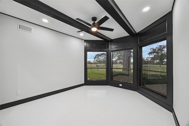 tiled empty room with beam ceiling, ceiling fan, and a healthy amount of sunlight