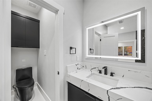 bathroom with vanity and toilet