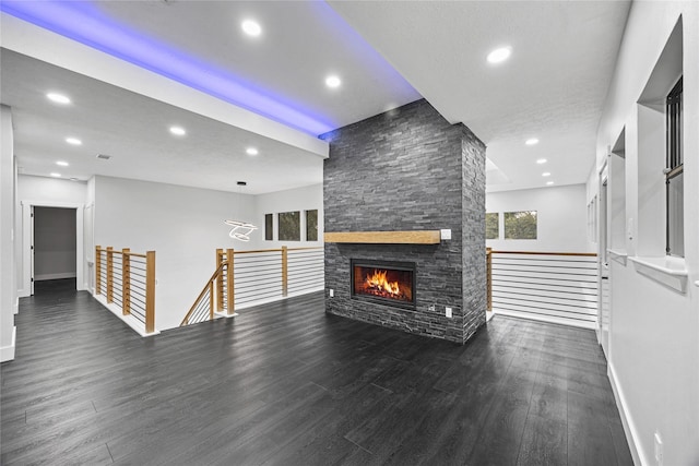 living room featuring a fireplace and dark wood-type flooring