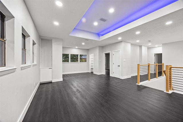 unfurnished living room with dark hardwood / wood-style floors